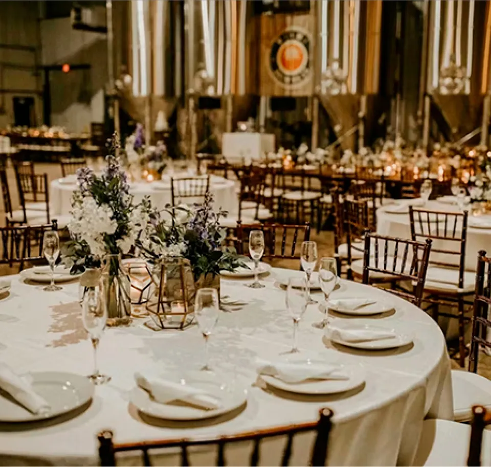 Spacious indoor venue at NOVA 535 with wooden ground and white chairs