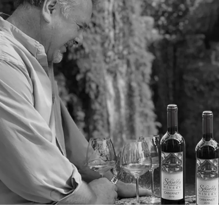 Indoor wedding ceremony at Nova 535 with brick wall backdrop, hanging lights, floral arch, and elegant bridal party setting