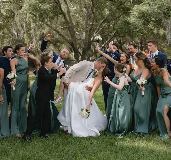 Indoor wedding reception at Trellis 925 with brick walls, draped ceilings, string lights, and elegant table decor