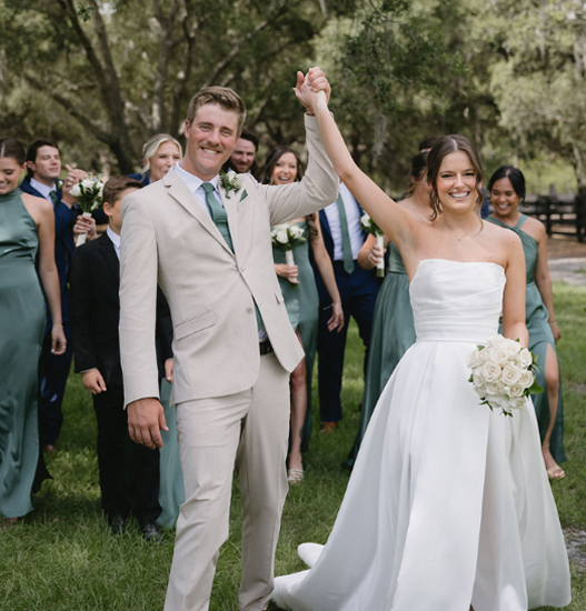 Rustic indoor wedding setup at Trellis 925 with draped ceiling, string lights, and elegant white table decor