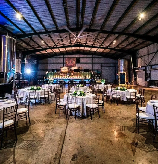 Bride and groom joyfully exit under sparkling lights at Schnebly Redland’s Winery, surrounded by cheering guests holding sparklers