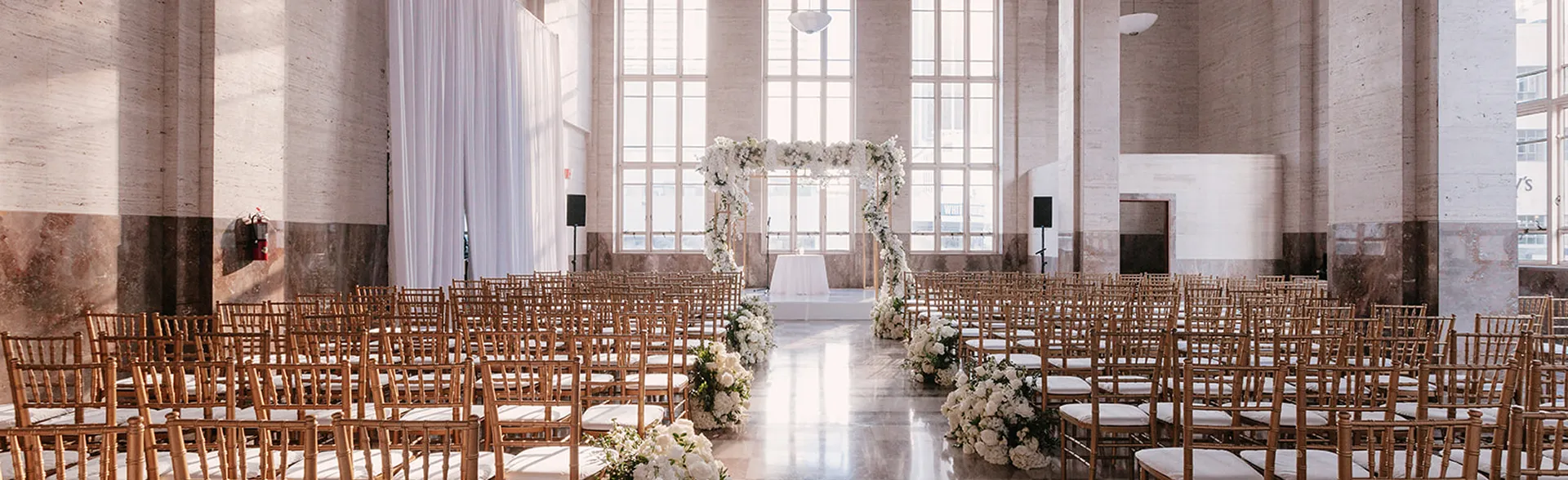 Exterior view of Coral Gables Country Club with palm trees, a golf course, and a clubhouse