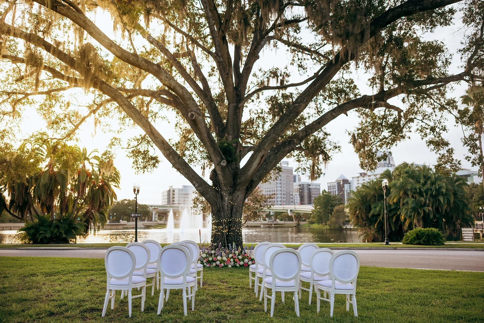 Brick patio reception setup with green chairs and string lights at The Woodruff
