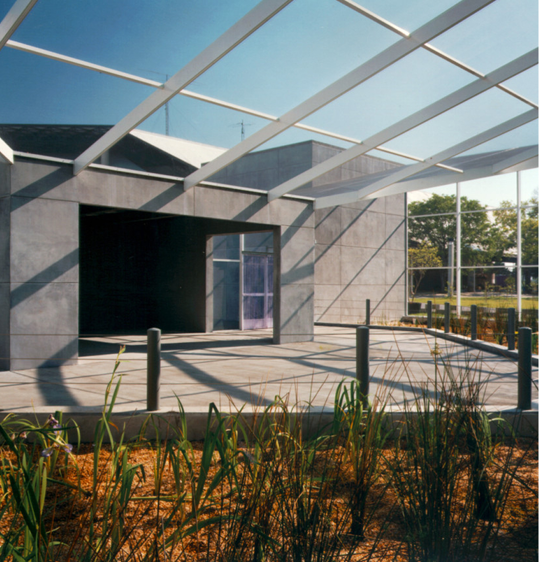 Modern outdoor plaza entrance at MOSI with geometric canopy and landscaped walkways