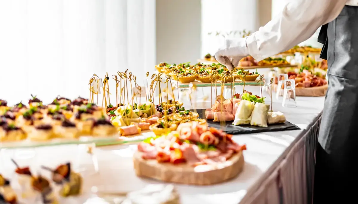Elegant catering table with assorted appetizers and finger foods arranged for a wedding reception