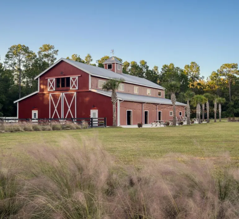 Aerial view of Tringali Barn at Heritage Farms showing the 54-acre property with lakes and natural beauty