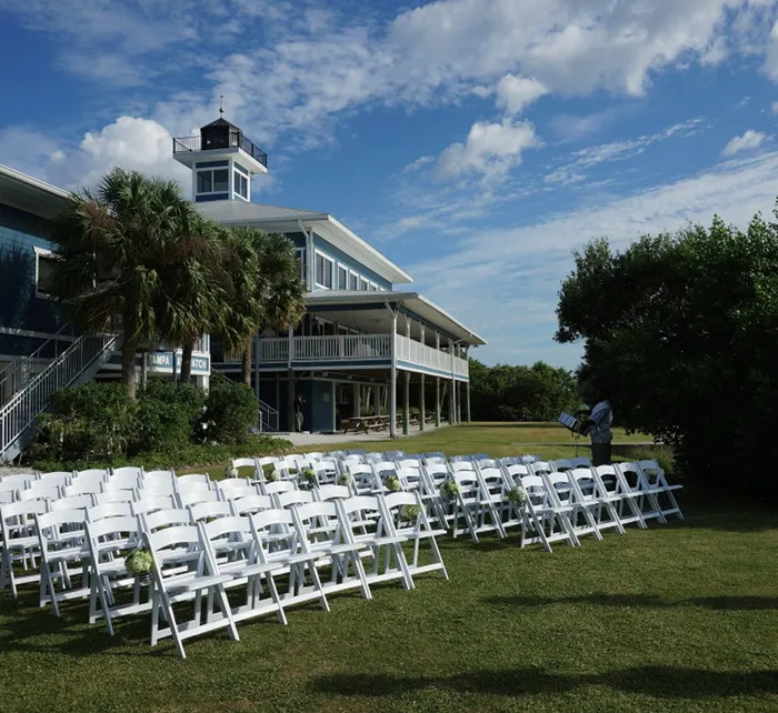 Outdoor view of Tampa Bay Watch venue showing the balcony, white railings, and covered seating area