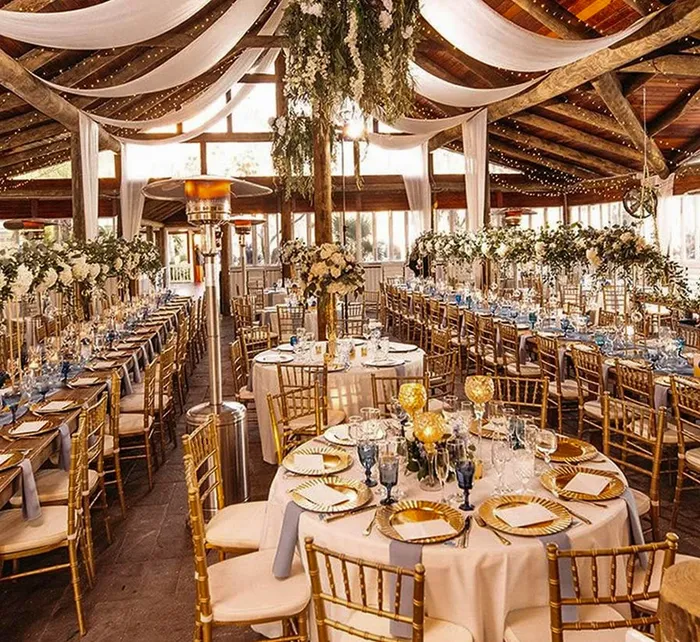 Outdoor wedding at Paradise Cove Orlando with string lights and a rustic wooden pavilion beautifully lit at dusk